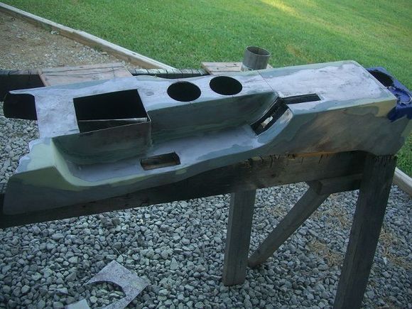 center console-I stripped out the wet dog smelling stock interior, and the new interior will be all metal with the exception of the seats. FYI...Don't buy cheap hole saws. I used 3-4" exhaust for the sides and bottom of the cup holders