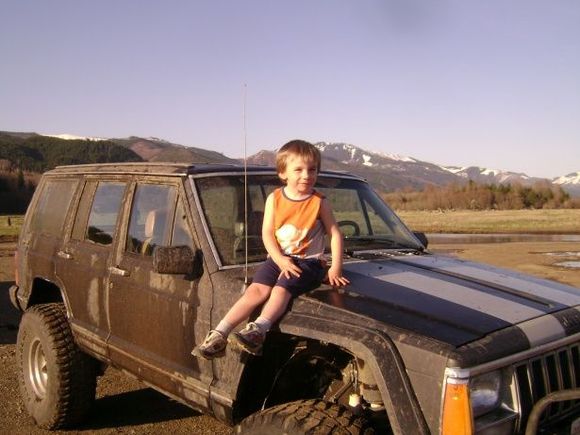 The nephew posing with the jeep down at the lake