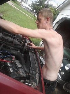 SprintPhoto my ole man playin with the radiator fluid cap. lol