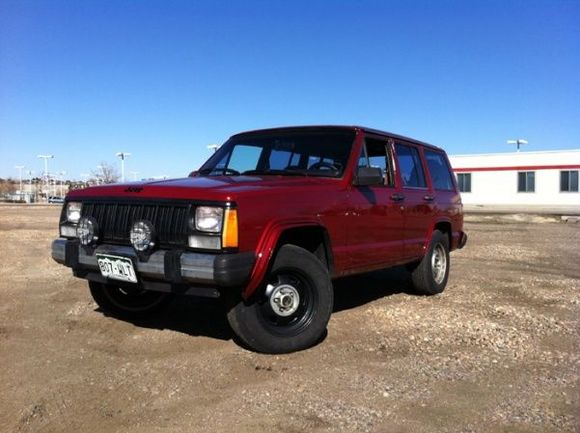 XJ Jeep Inferno Red Full side before lift and tires.