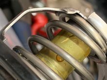The brass centre part that has the wax in it, it can rattle and rub against the bracket see that scratch line
