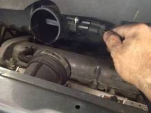 That’s it in the plastic tube towards the air filter box, and yes the elbow should be connected to that tube, it’s a stock photo with the tube disconnected for visibility 