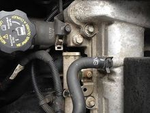 The bolt between the air box stud and the valve cover bolt, it is actually a plug in the cylinder head to the coolant passages 