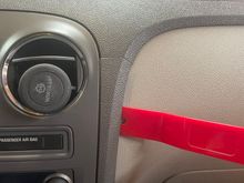 Remove the radio trim by prying outward about 2" down from the seam. Pull the trim out and tilt the section outward. It is not necessary to remove this part or disconnect the wiring.