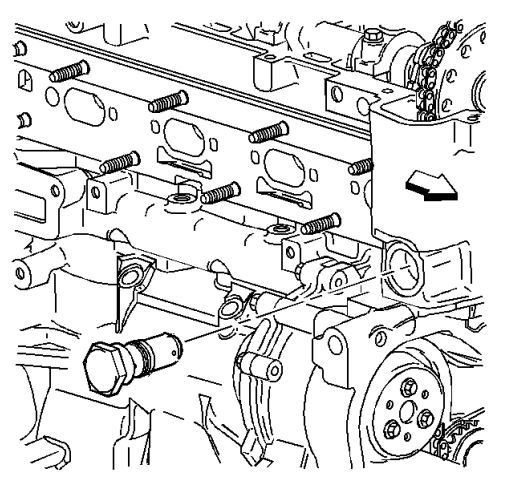 The tensioner is on the back of the engine. Loosen with a 32 mm socket.