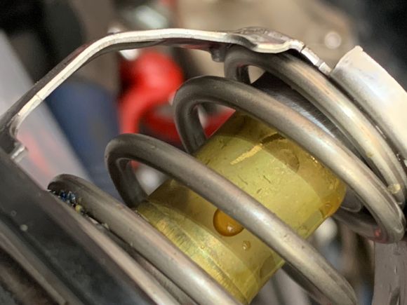 The brass centre part that has the wax in it, it can rattle and rub against the bracket see that scratch line