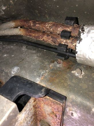 That’s the EVAP canister, the black plastic and metal bracket, the lines are above that the insulation sleeve is just in the upper right of the photo 