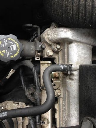 The bolt between the air box stud and the valve cover bolt, it is actually a plug in the cylinder head to the coolant passages 