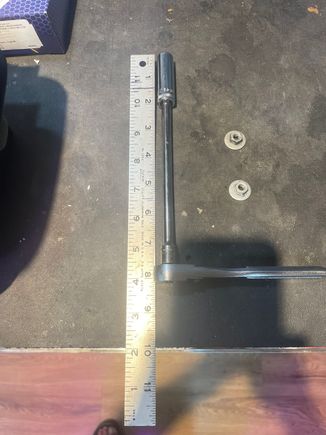 Get a 10 mm socket with an extension, 1/4".