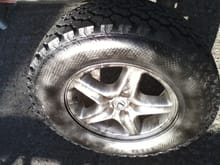 rx300 wheel  if u look real close u can c it is painted with ghost roses and wrapped in a 255/65/ general grabber at tire