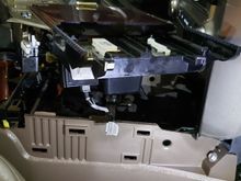 Remove the center console for wire access. Plenty of space here.  I used electric tape and padded tape to reduce any rattling of installed components.