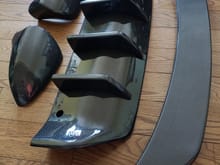 CF replacement mirror covers (not caps), rear diffuser and rear trunk spoiler.