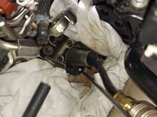 The trickiest valve is the one to the right of the pointer. Not visible in the picture.  It's behind the spark plug stack.  It's very difficult to see in person.  Contending with the mess of fuel lines adds to the fun.