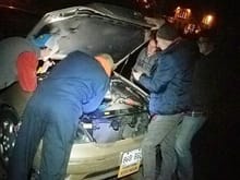 Temp sensor repair pit crew. Also note me (Blue puff jacket / red shoes) holding the hood up since one of the struts blew.