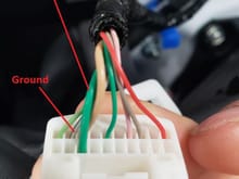 Thicker green wire is 12v.  Thinner white wire with black stripe is ground.