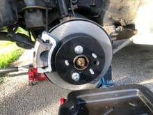 The rears, aluminum caliper that is wide enough to accommodate a wider rotor while using regular 3RX pads