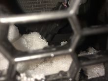 Drivers side close to the fog lights