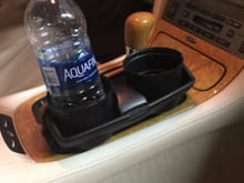 Gang

Here is my "$1" cupholders I spray painted Black
It works perfectly And a great way to keep
your bottles from taking off when turning :)