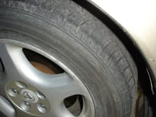 Groove is worn into both faces of the tire.