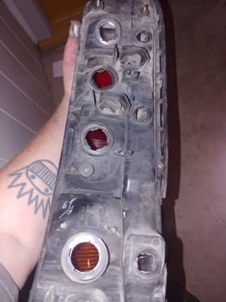 Back of stock '96 tail light. Note the blinker light mounts are slanted and mount in a sideways fashion.. also note The number of light mounting holes. I count 7 total light housing mounts.