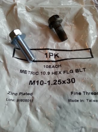 Original bolt is M10-1.25 X 20  hex head bolt zinc-plated with captive washer.

Adding upper plate necessitated increasing to 30mm length.

Purchased JIS M10-1.25 X 30  flange heat  bolt, grade 10.9 from McMaster-Carr . Perfect fit.