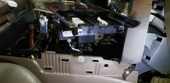 Remove the center console for wire access. Plenty of space here.  I used electric tape and padded tape to reduce any rattling of installed components.