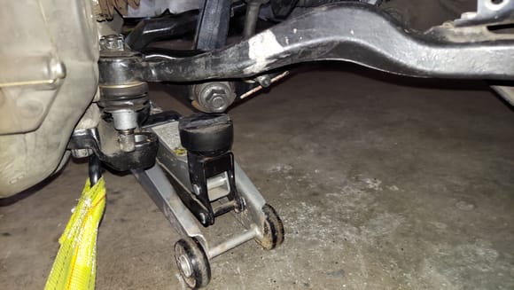 Getting the lower rear arms lined up into the knuckle / ball joint proved to be tricky.  I couldn't get enough leverage by hand to line them up.  The new bushings were tight! ( picture of the left front looking forward)