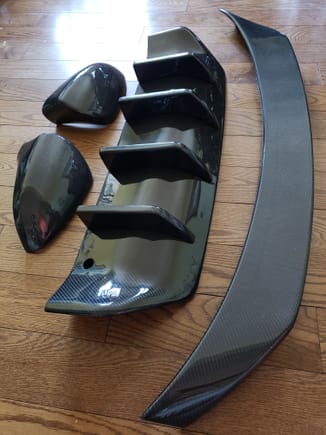 CF replacement mirror covers (not caps), rear diffuser and rear trunk spoiler.