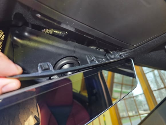 Work the clips free with steady downward pressure from left to right as you rock the panel down. Once the clips are free, pull the panel towards you as there is only a hooked portion on the right side allowing it to rest in the headliner.