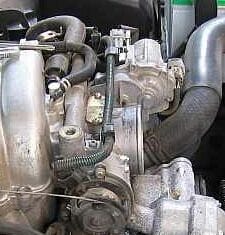 An image located online showing the wiring harness atop throttle body with two plastic clamps