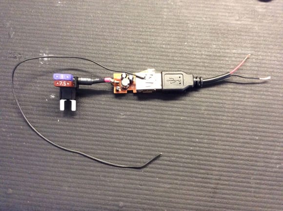 I disassembled a standard car auxiliary to USB adaptor that is needed to bring the voltage down to 5V