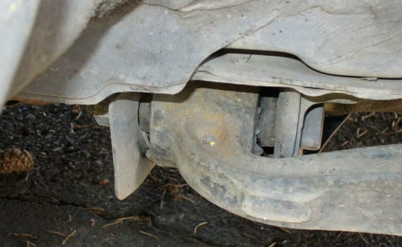 Rearmost bushing of the right front lower control arm.