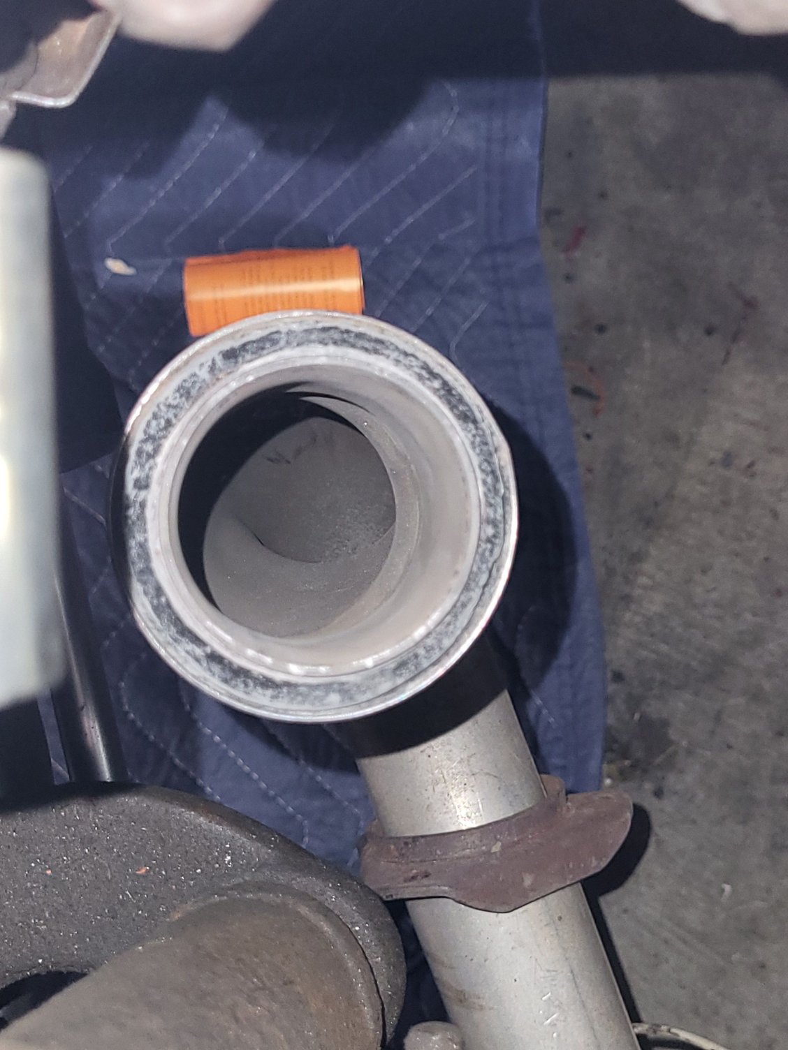 Smaller donut suspending flanged sleeve in downpipe. 