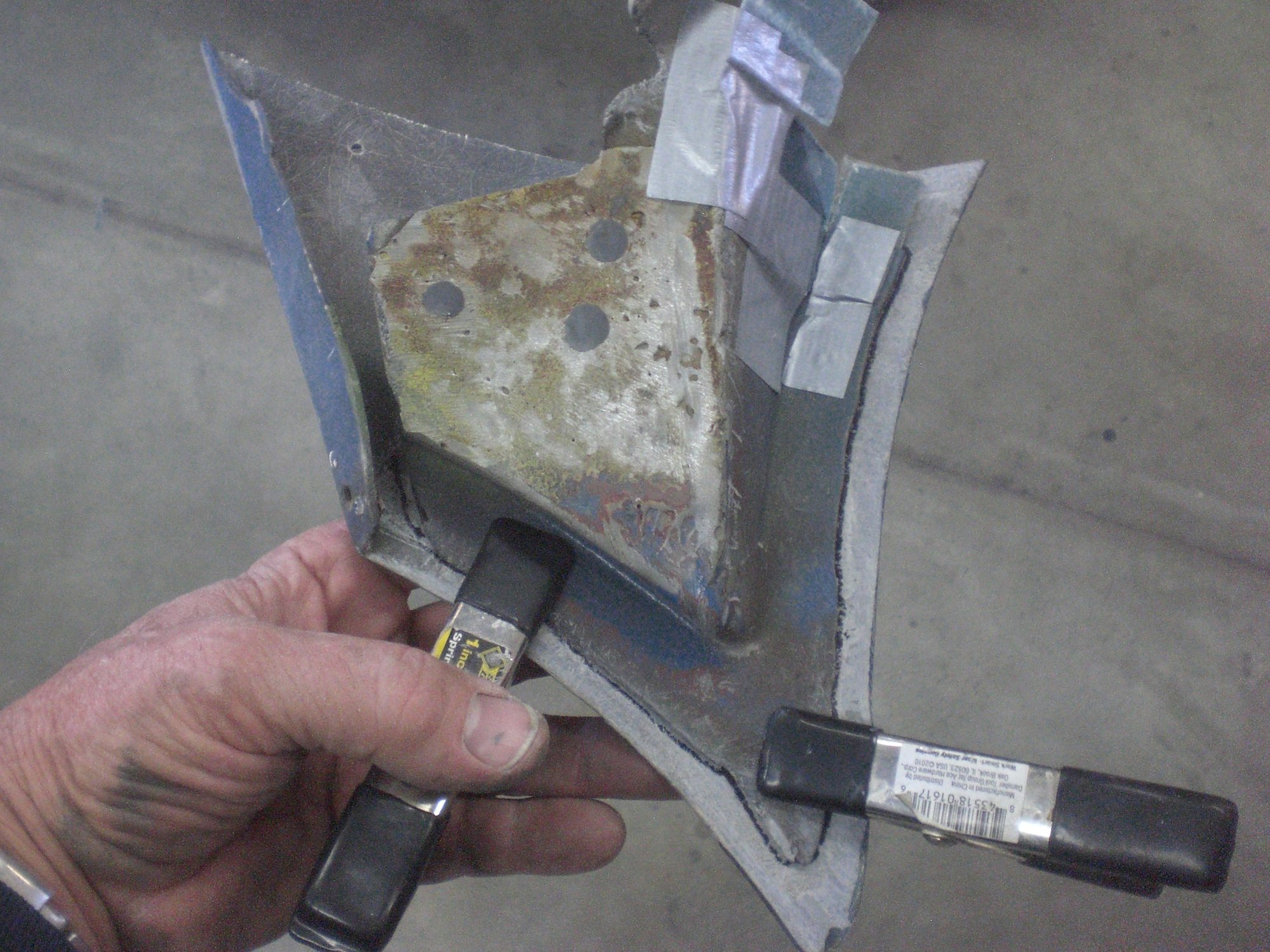 Fender tip and bonding support piece glued back together in using remaining original placement markings.  Tape held some small self-made fiberglass bonding tabs that will be used to mate it to the fixed remaining support structure that is still in place