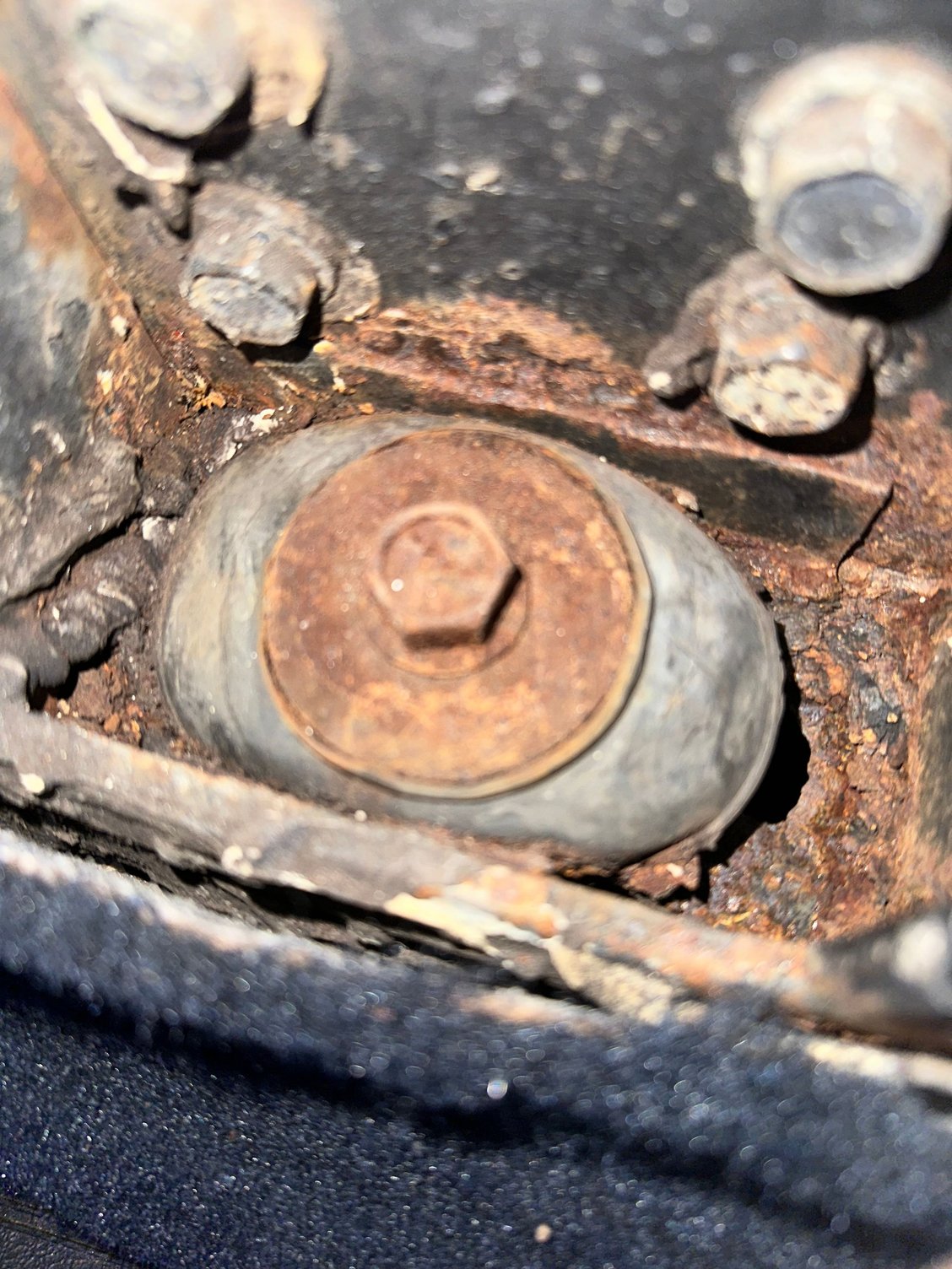 This is the passenger side number to mount. Most concerning thing I could find. You can see the small hole in the metal on the right side of the rubber gasket.