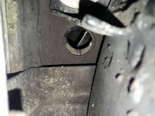 Under car passager side, behind body mount which is behind the passager front wheel.