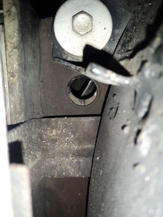 Under car passager side, behind body mount which is behind the passager front wheel.