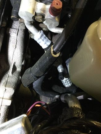 You can see the black Cover of the added valve above the silver metal crimp on the rubber hose.