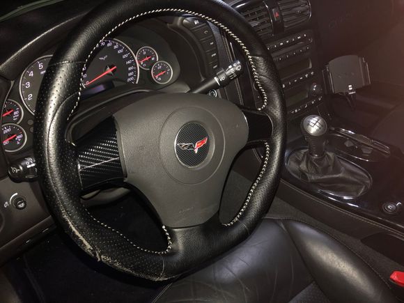 Added new steering wheel and wrapped the silver spokes in Carbon Fiber
