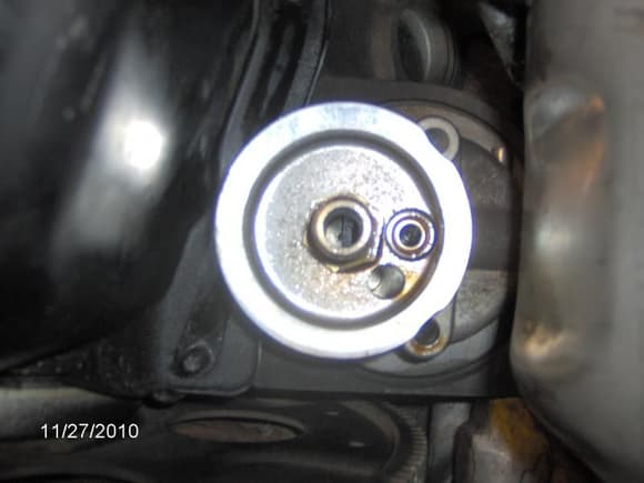 Oil filter adapter (on engine) with two bolts removed.