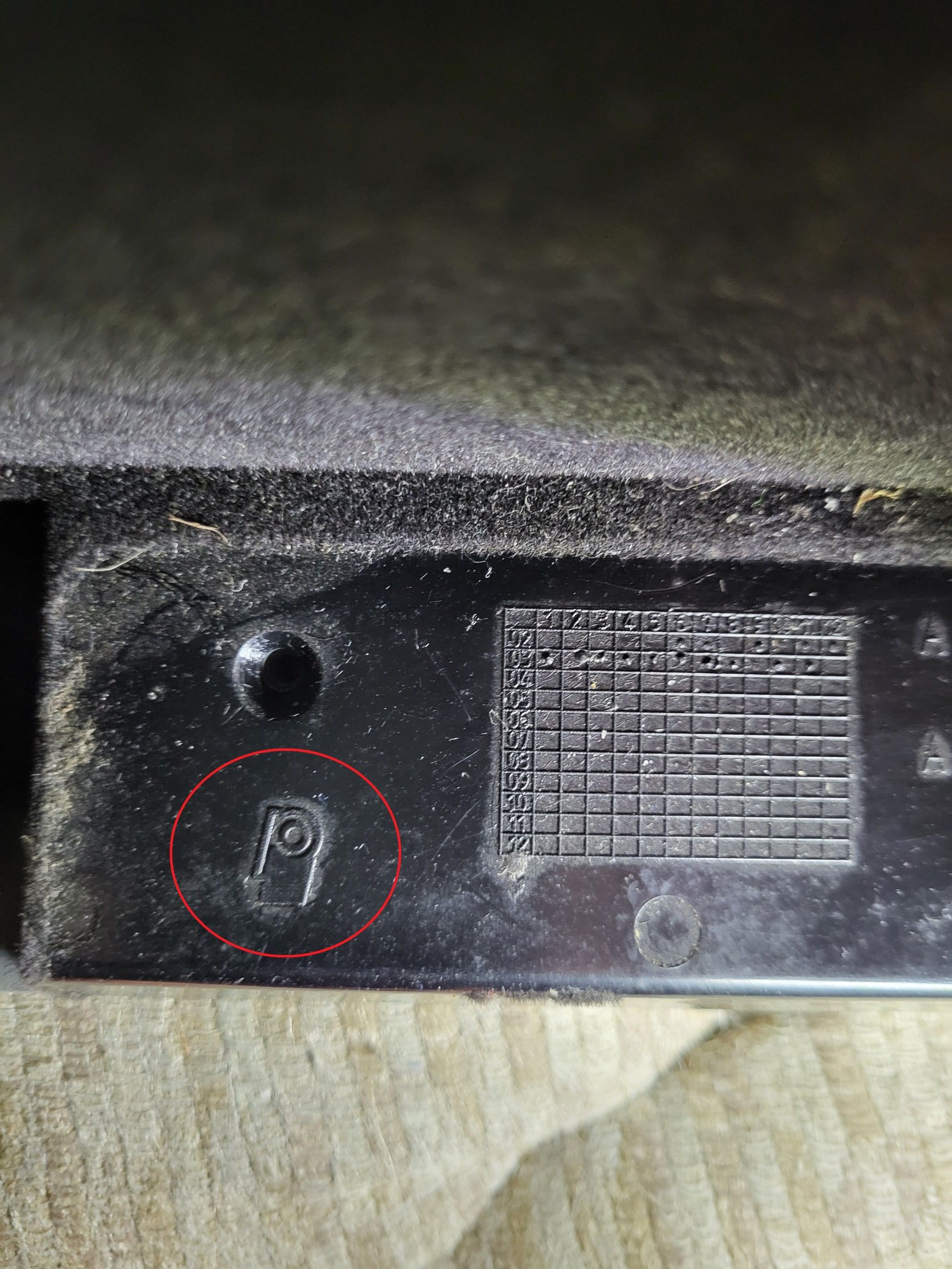 This is located in back edge of glove box door.