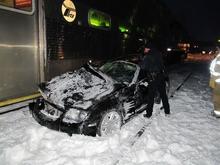 stuck in the snow on the tracks, 72mph train hit, no one hurt, no one in the car,