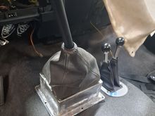 I built a riser for the shifter to use the OE G56 shifter and boot.