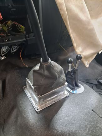 I built a riser for the shifter to use the OE G56 shifter and boot.