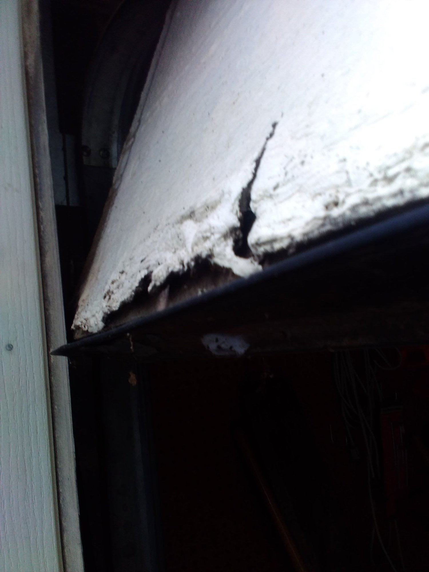 Veneer on Garage Door Panel Cracking. How to Fix ?