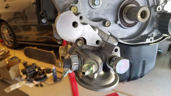 After bolting on the oil filter housing, I used a breaker bar to take off the two oil plugs on each side to replace with oil fittings.  The right sized allen socket and breaker bar gets these loose without any heat.  This is done so I can have an oil source for my oil pressure gauge and one for my turbo.  One of these is post filter for the turbo.   I also installed a new oil pressure sending unit.  I used high temp thread sealant on everything instead of yellow teflon tape.