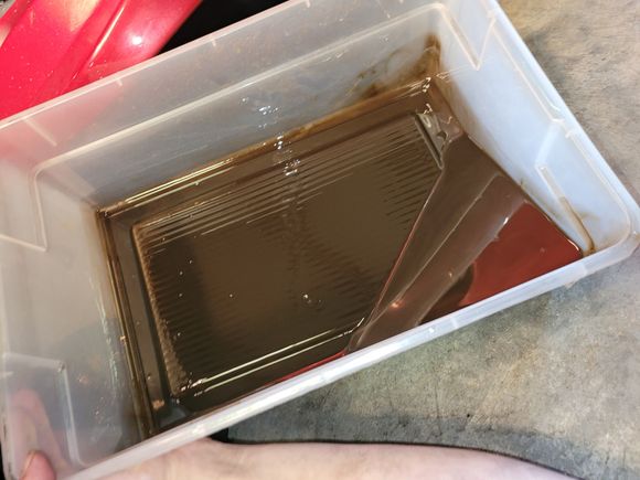 Fluid after drain and about half a quart of new fluid to flush