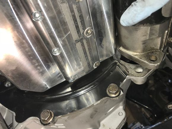 Starter against oil pan
