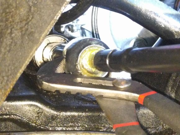 Crimping the lock washer on the inner tie rod with a pipe wrench.