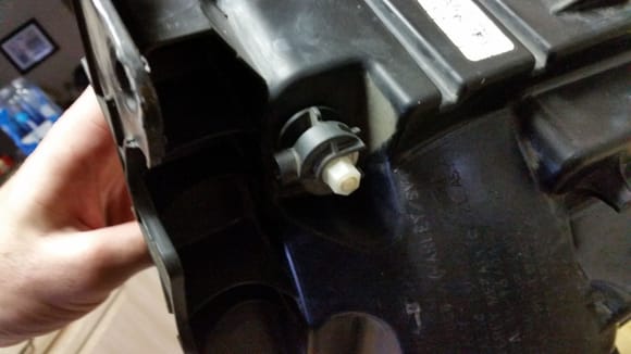 this is the adjuster knob attached to the second "screw". i gave the black part a counter clockwise turn to unlock. once unlocked, i took a socket wrench, with a 10mm bit i think, and unscrewed the white portion of the knob. after some turning, the knob will come off